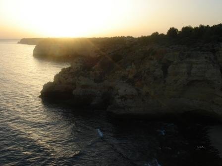 sunset over atlantic cliffs algarve carvoeiro portugal