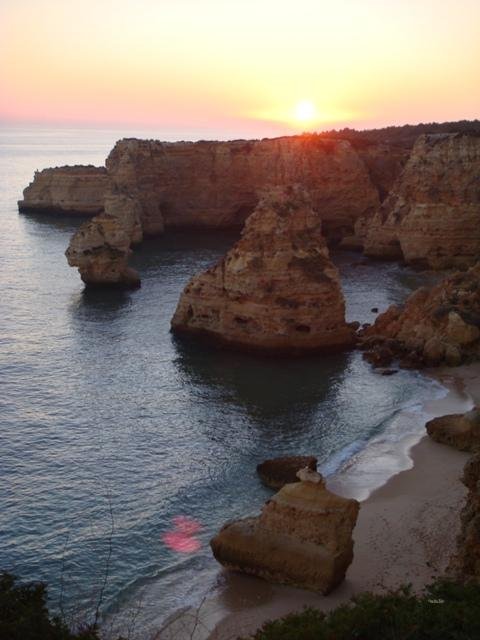 sunset over algarve cliffs near carvoeiro portugal