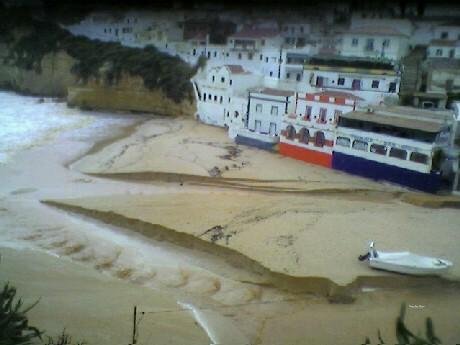 rainwater flowing across carvoeiro beach sand algarve portugal