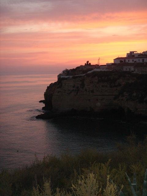 sunset over carvoeiro cliffs and ocean