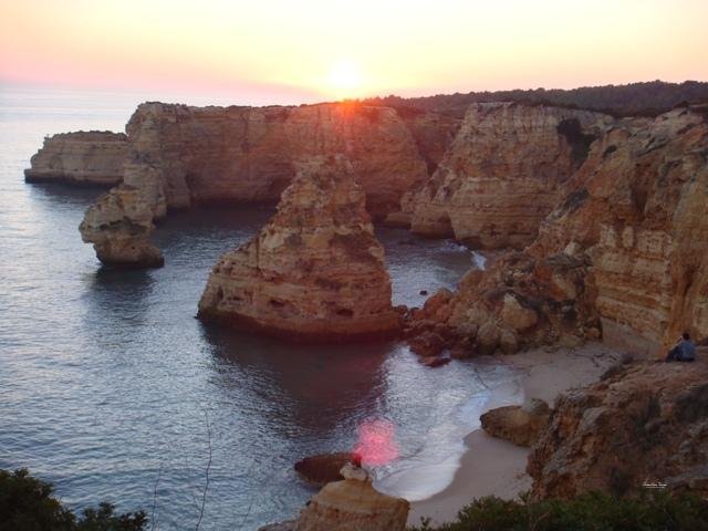 rock formations marinha beach sunset