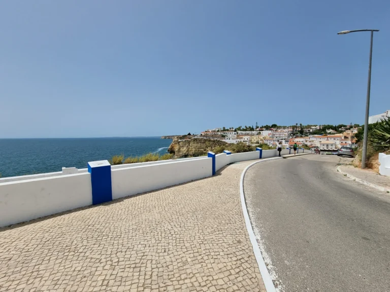 coastal street leading to ocean view terrace carvoeiro portugal