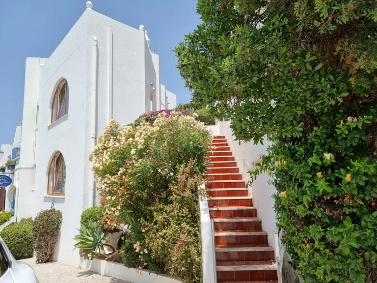 stairs leading down to ocean view terrace carvoeiro algarve portugal